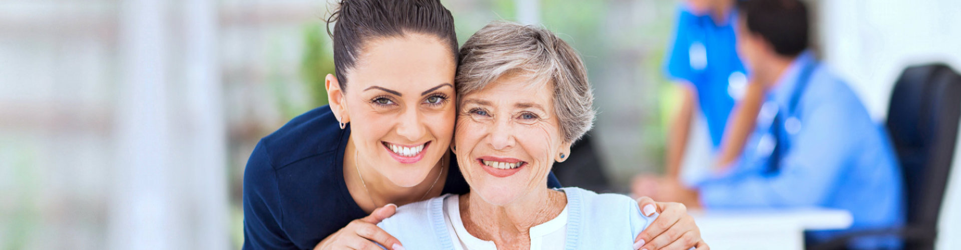 caregiver and senior woman are smiling